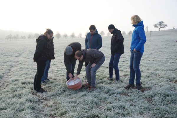 Diskussionen auf einem winterlichen Acker am frühen Morgen